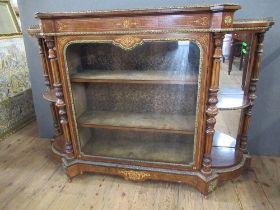 A late 19th century burr walnut credenza with central glazed door flanked by quarter open shelves