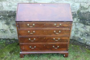 A late Georgian mahogany fall flap bureau, with doors and pigeon holes, with four drawers below,
