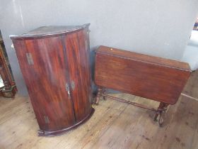 A Georgian mahogany corner cupboard, together with a 19th century mahogany Sutherland table