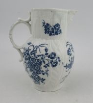 An 18th century cabbage moulded Caughley mask jug, decorated with flowers in underglaze blue, S