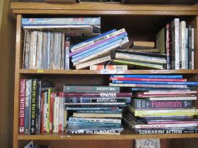 Two shelves of books, including military history examples