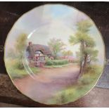 A Royal Worcester plate, decorated with a view of Harvington by R Rushton, diameter 11ins