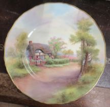 A Royal Worcester plate, decorated with a view of Harvington by R Rushton, diameter 11ins