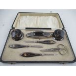 A boxed 1920s silver and tortoiseshell manicure set, together with set of six silver tea spoons,