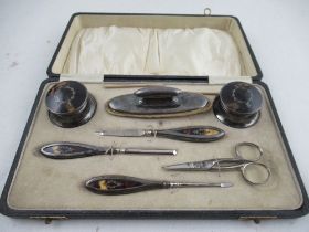 A boxed 1920s silver and tortoiseshell manicure set, together with set of six silver tea spoons,