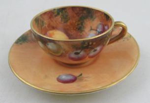 A Royal Worcester miniature tea cup and saucer, decorated with fruit by Roberts