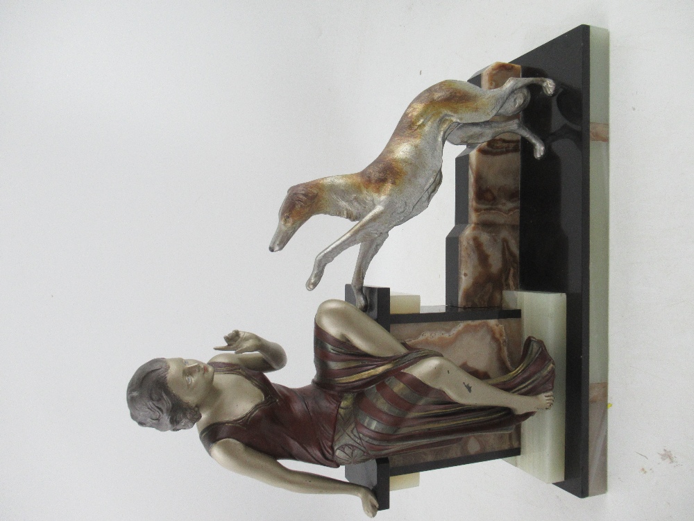 A large Art Deco model, of a lady and dog, on an onyx and marble base, width 17ins, height 17ins