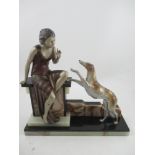 A large Art Deco model, of a lady and dog, on an onyx and marble base, width 17ins, height 17ins
