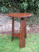 An Arts and Crafts style circular occasional table, diameter 17ins, height 27ins