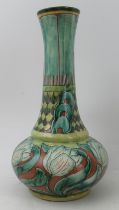 A Della Robbia earthenware vase, with trumpet neck, the body decorated with flowers, height 13ins