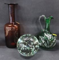 A Victorian green glass paperweight, together with a green water jug with floral decoration and a