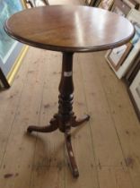 A mahogany circular topped tripod table, raised on a turned column and three outwept supports,