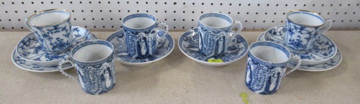 A pair of blue and white onion pattern trio's, together with four coffee cans and two saucers