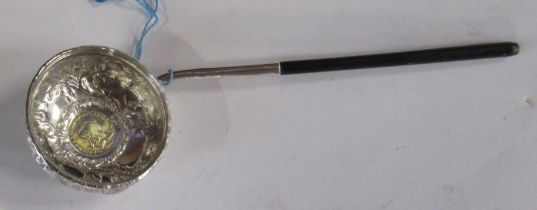 An antique silver toddy ladle
