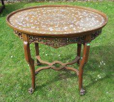 An Eastern oval wooden and inlaid occasional table, inlaid with mother of pearl, having a pierced