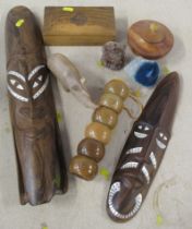 Box of carved wooden items, to include two inlaid wall masks and olive wood box