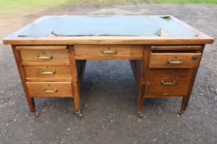 An early 20th century oak desk, fitted with a central drawer, flanked by drawers and sides, 60ins