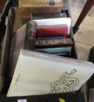 A box of books, including Dickens