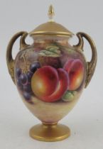 A Royal Worcester covered pedestal vase, decorated to the front with fruit to a mossy background