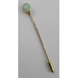 A yellow gold tie pin, set with a cabochon opal, weight 1.5g