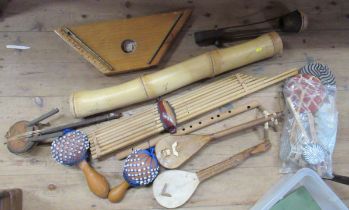 A collection of continental instruments, to include a zither, drums, pipes ect