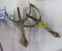 A pair of antique brass spurs, stamped, Piccadilly, London