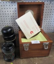 A boxed Curta calculating machine, Type 2,  together with a poster showing the mechanics of the