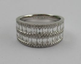 An 18k white gold diamond ring, channel set, the two rows of baguette cut diamonds highlighted