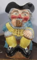 A Clarice Cliff toby jug, of a seated man drinking beer, height 9ins Condition Report: Generally