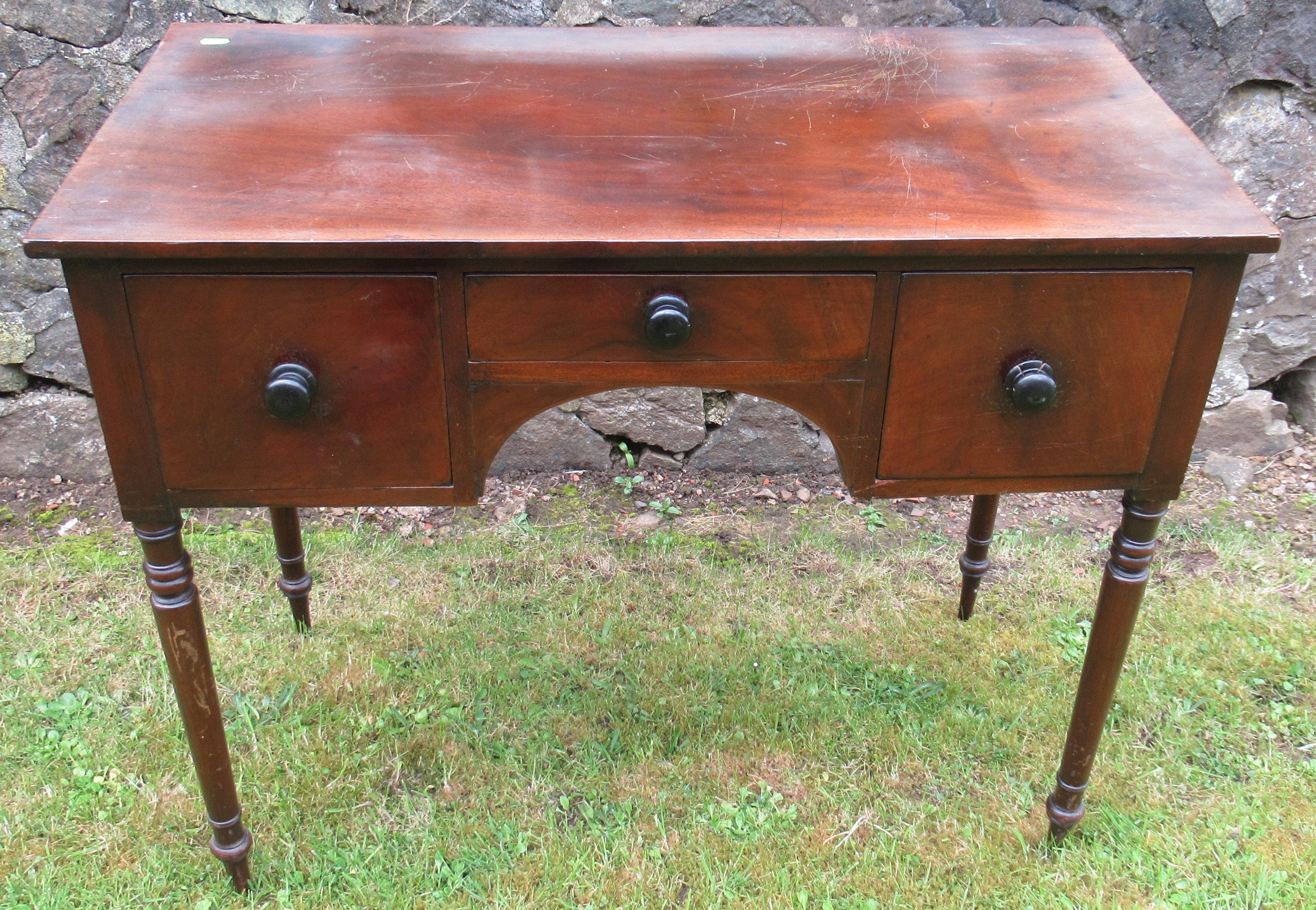 A 19th century mahogany sidetable, fitted with three drawers, on ring turned supports, 36ins x