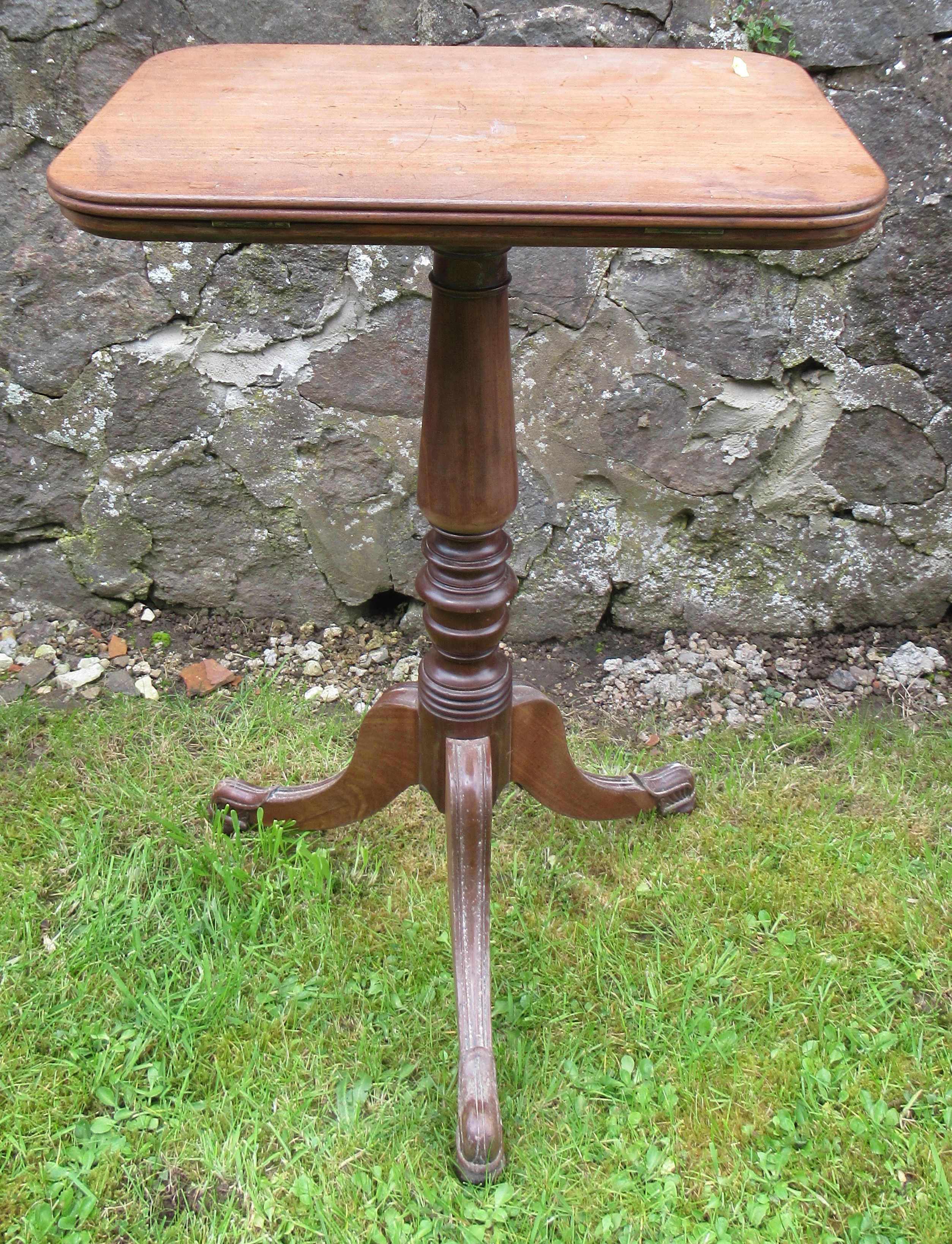 A 19th century mahogany rectangular top occasional table, on turned column, with carved outswept