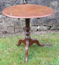 A 19th century oak tripod table, raised on a turned column, with three outswept supports, diameter