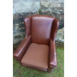 A leatherette upholstered arm chair