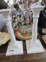 A pair of Royal Worcester candlesticks