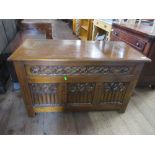 An oak coffer with carved front width 42ins depth 19ins, height 26ins