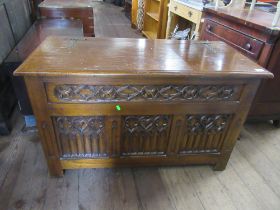 An oak coffer with carved front width 42ins depth 19ins, height 26ins