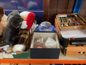 A collection of toys, stuffed animals, model cars, table top games, glass etc