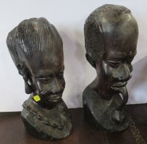 A pair of carved wooden African busts, height 11ins