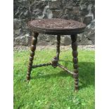 An antique oak occasional table with carved decoration