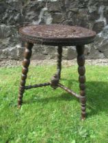 An antique oak occasional table with carved decoration