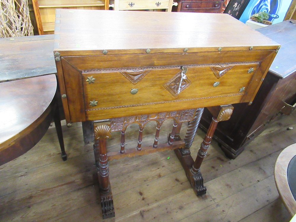 An Anglo-Portuguese design desk with drop flap opening to reveal draw, raised on turned supports