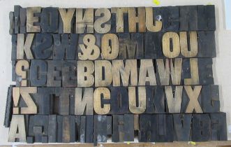 A collection of wooden block printing letters, together with a wine box and brass door plate