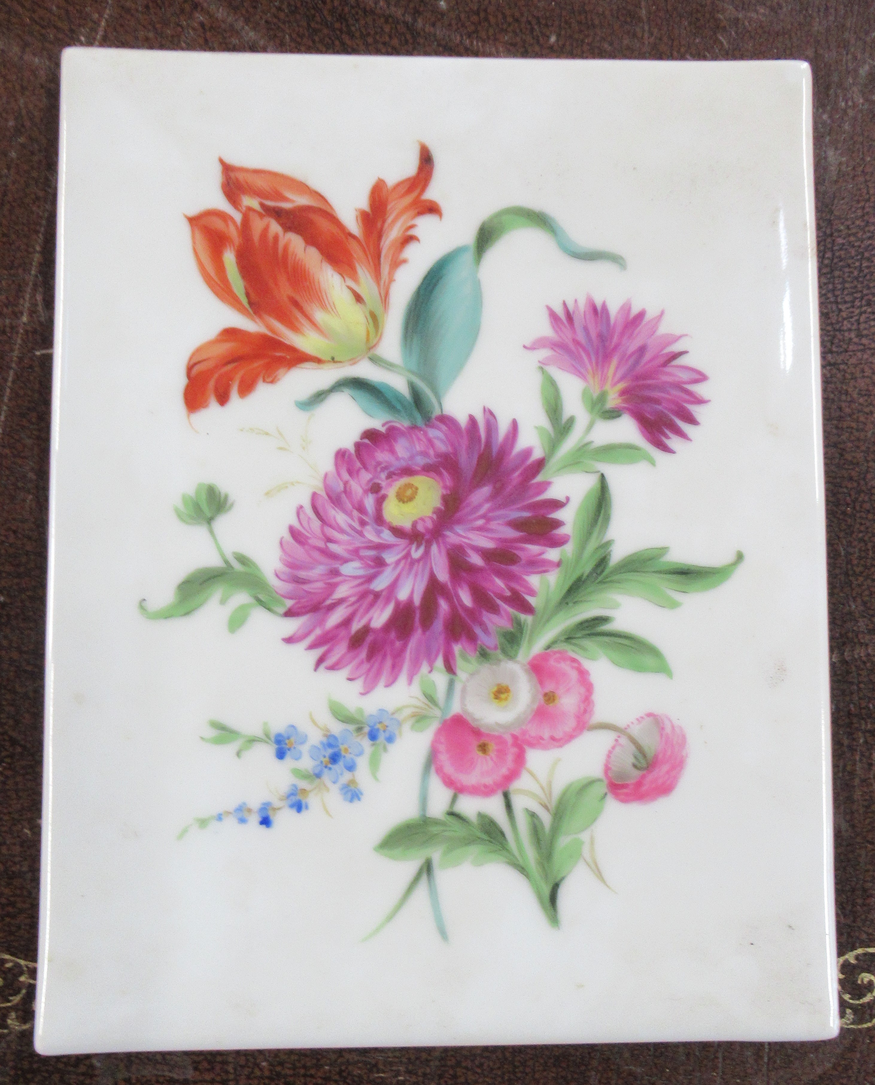 A rectangular porcelain plaque, decorated with flowers, marked to the back Handmalerei, 9ins x 7ins
