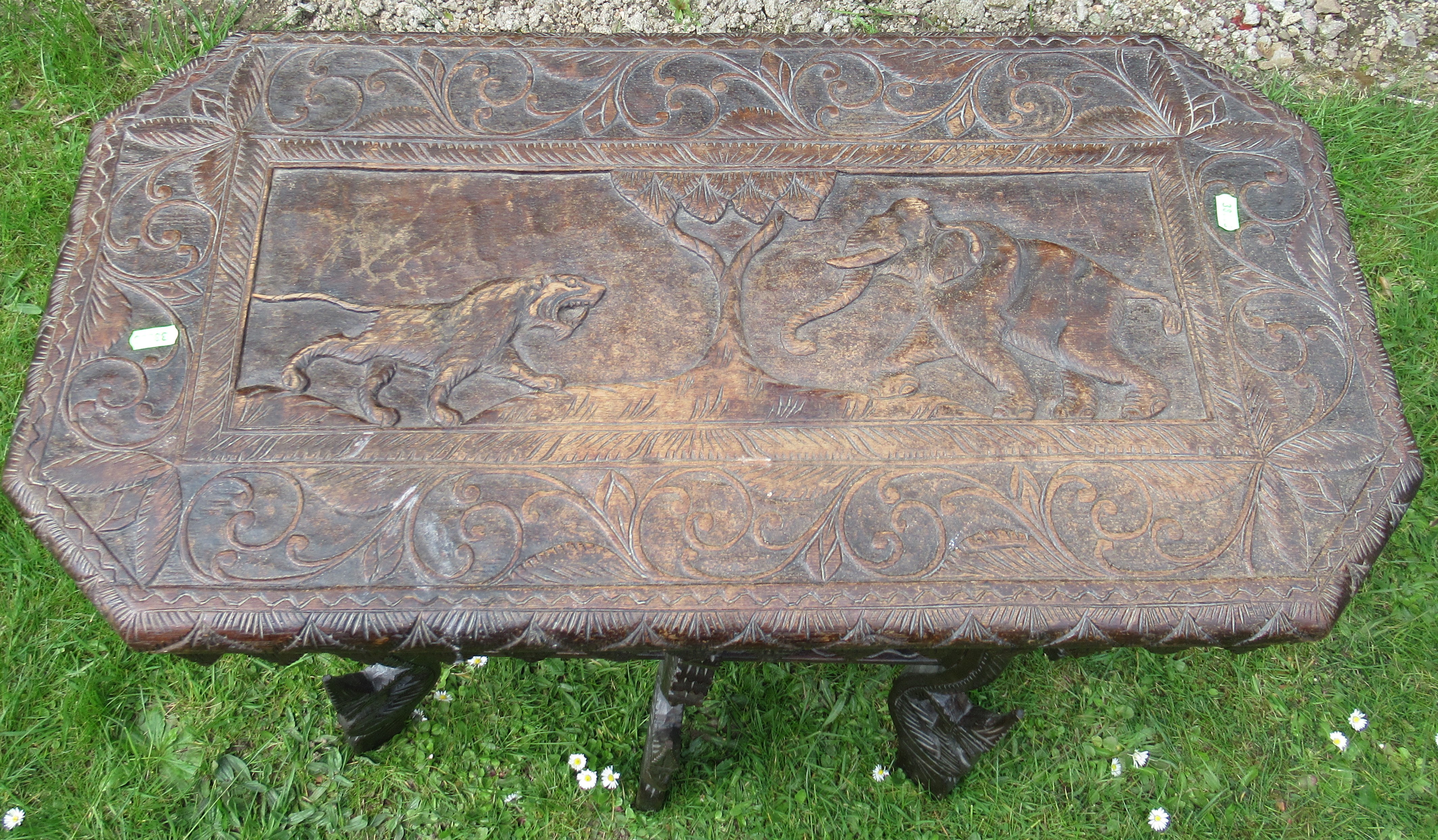 A carved oak occasional table, the top decorated with fielded panel of elephants and large raised on - Bild 2 aus 2