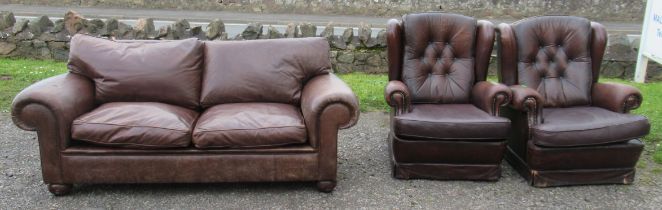 A two seater settee, in brown leather, together with a pair of armchairs