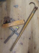 Two walking sticks, hand wood plainer, metal figure and crucifix