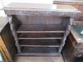 An oak set of shelves with carved decoration width 42ins height 46ins