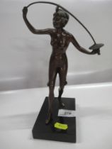 A bronze model of a lady holding a sword