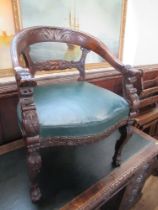An Antique oak tub chair, with carved decoration and leather seat