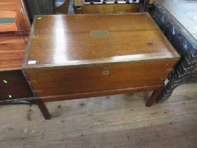 A mahogany chest with brass banding and carrying handles raised on a stand width 36ins depth 22ins